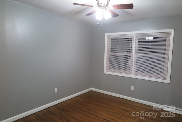 empty room with ceiling fan and dark wood-type flooring