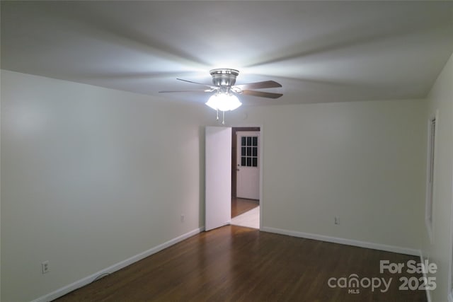 spare room with dark hardwood / wood-style flooring