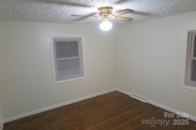 spare room with ceiling fan, dark hardwood / wood-style flooring, a textured ceiling, and a baseboard radiator