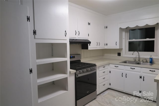 kitchen with stainless steel gas range oven, light countertops, under cabinet range hood, a sink, and white cabinets