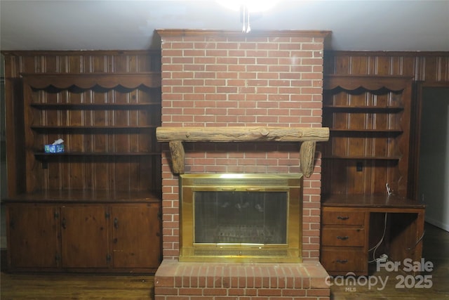 details featuring a fireplace and wood finished floors