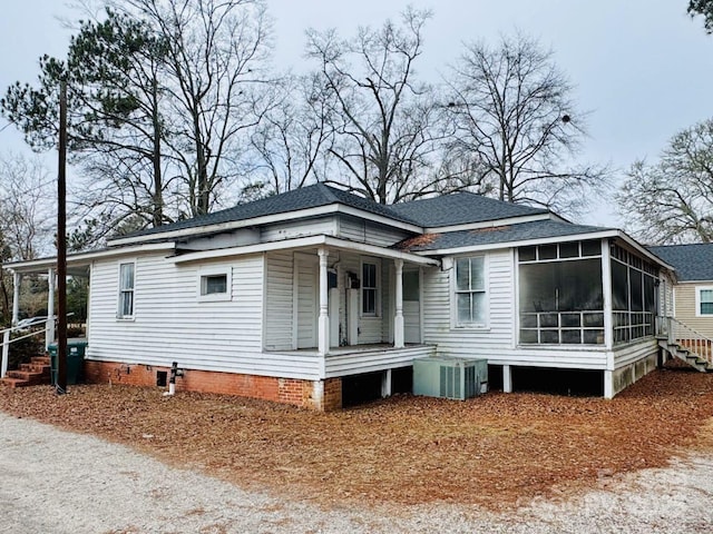 exterior space featuring cooling unit and a sunroom