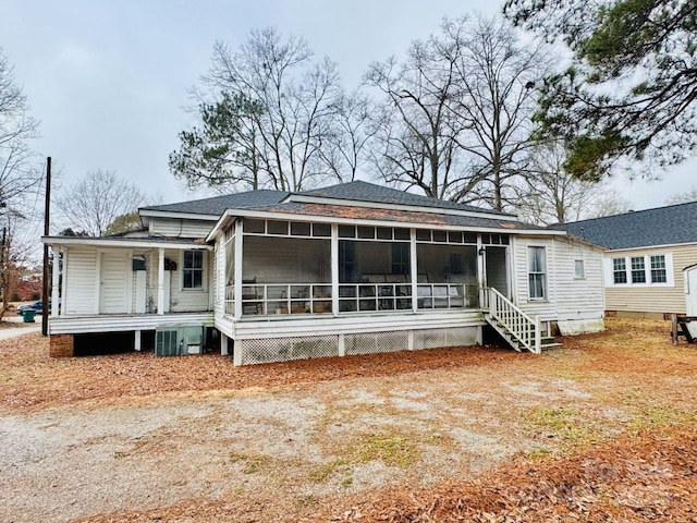 rear view of property with a sunroom