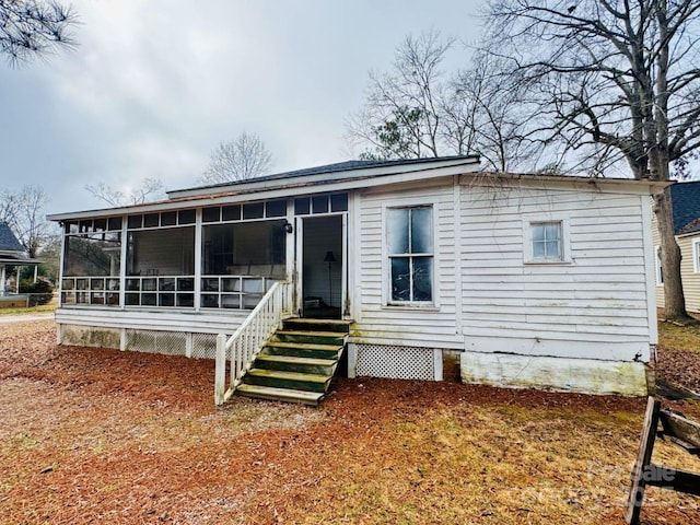 view of front of house featuring a sunroom