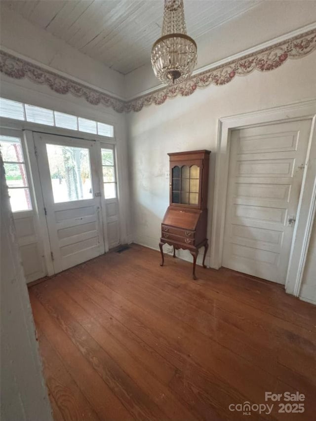 entryway with a chandelier and hardwood / wood-style flooring