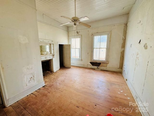 unfurnished living room with ceiling fan and light hardwood / wood-style flooring