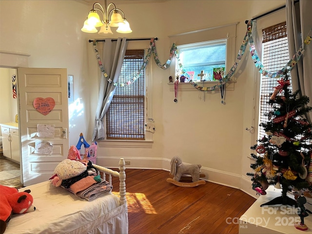 bedroom with an inviting chandelier and hardwood / wood-style flooring