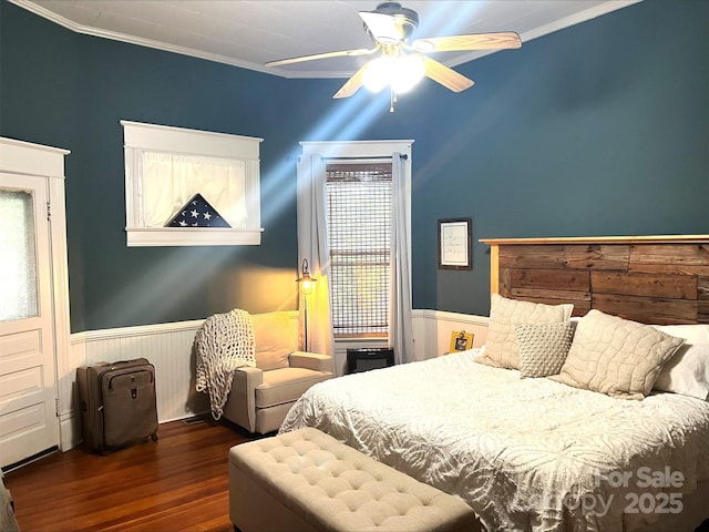 bedroom featuring ceiling fan, multiple windows, dark hardwood / wood-style flooring, and crown molding