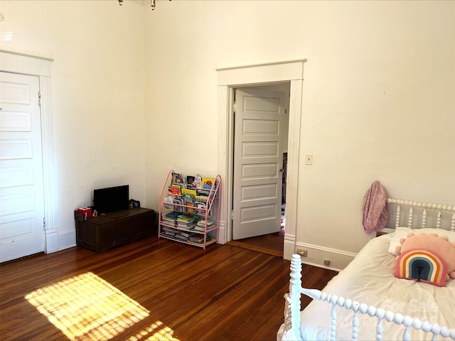 bedroom with dark hardwood / wood-style floors