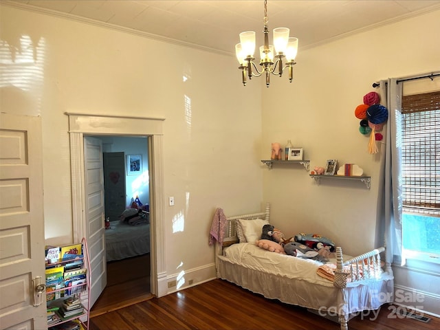 bedroom featuring an inviting chandelier, dark hardwood / wood-style flooring, and ornamental molding