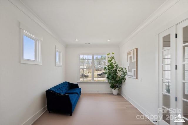 sitting room with ornamental molding, recessed lighting, wood finished floors, and baseboards