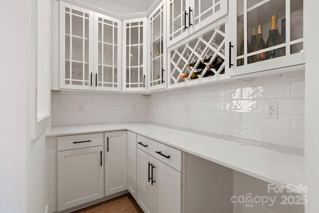 interior space featuring tasteful backsplash and dark wood-type flooring