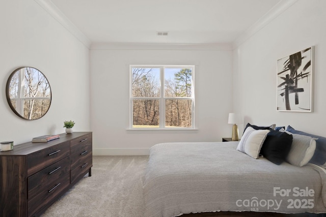 bedroom featuring ornamental molding, light carpet, visible vents, and baseboards