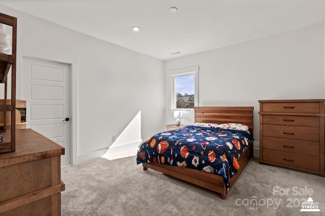 bedroom with light carpet and visible vents