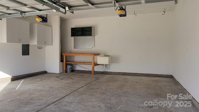 garage featuring electric panel and a garage door opener