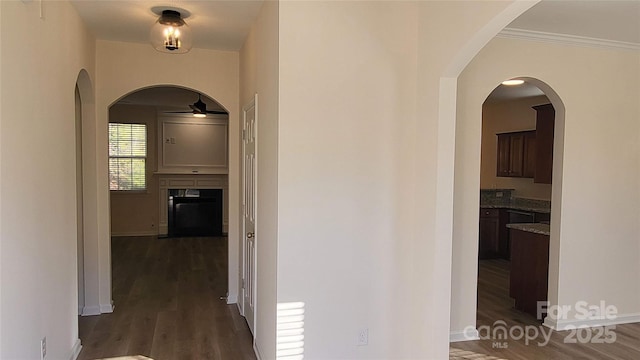 hall featuring dark hardwood / wood-style floors and crown molding