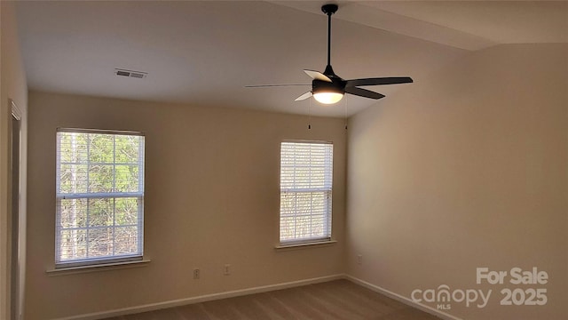 carpeted spare room with ceiling fan and lofted ceiling