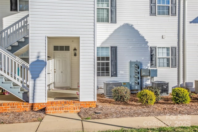 doorway to property featuring central air condition unit