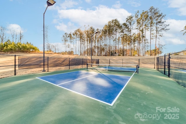 view of tennis court with basketball hoop