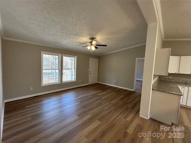 unfurnished living room with ceiling fan, dark wood-type flooring, a textured ceiling, and crown molding