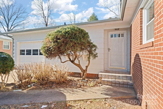 view of exterior entry with a garage