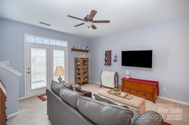 living room featuring light carpet and ceiling fan