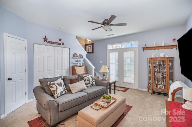 carpeted living room featuring ceiling fan