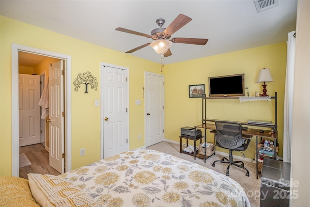 bedroom featuring ceiling fan, a closet, and light hardwood / wood-style floors