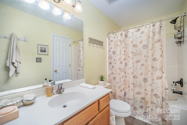 full bathroom featuring toilet, vanity, shower / bath combo with shower curtain, and hardwood / wood-style floors