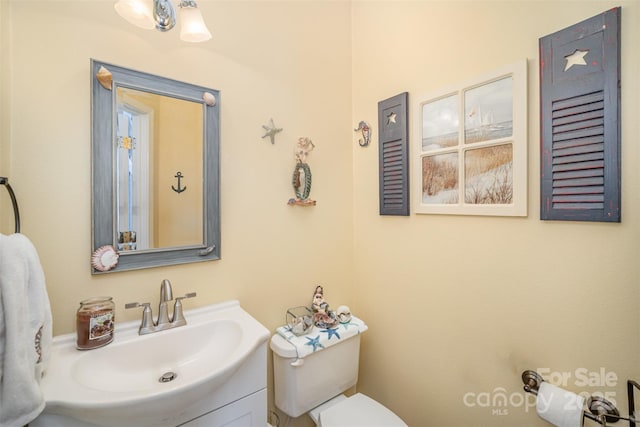 bathroom with toilet and vanity