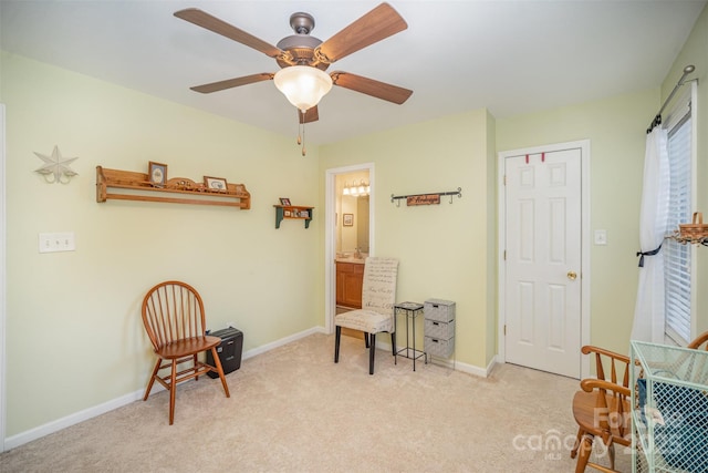 living area with ceiling fan and light colored carpet