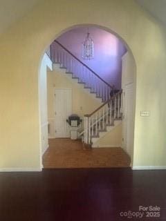 stairway featuring a chandelier and hardwood / wood-style flooring