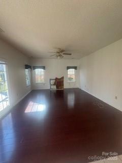 empty room featuring ceiling fan and hardwood / wood-style flooring