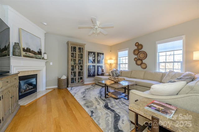 living room with ceiling fan and light hardwood / wood-style floors