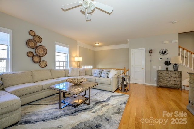 living room with ceiling fan and light wood-type flooring