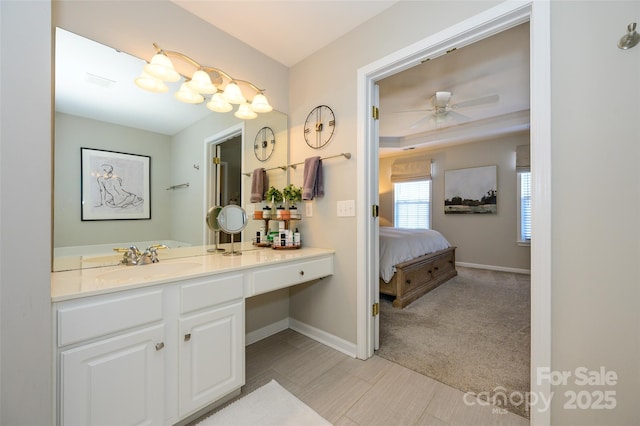 bathroom with ceiling fan and vanity