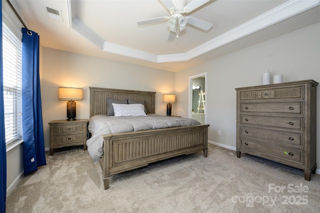 carpeted bedroom featuring ceiling fan, connected bathroom, and a tray ceiling