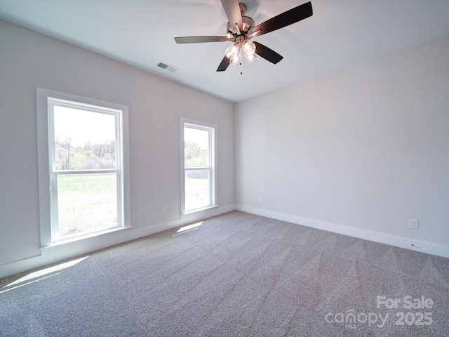 unfurnished room featuring ceiling fan and carpet floors