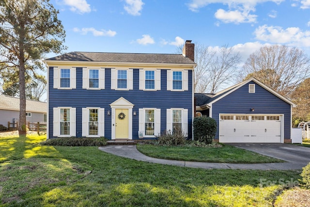 colonial house with a garage and a front yard