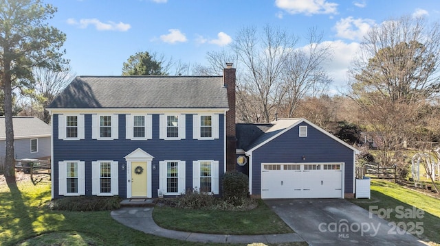 view of front facade featuring a front yard and a garage