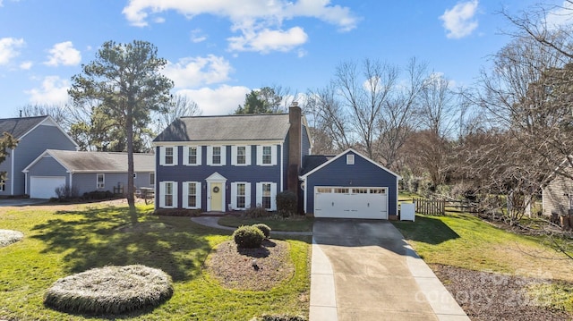 colonial home featuring a garage and a front lawn