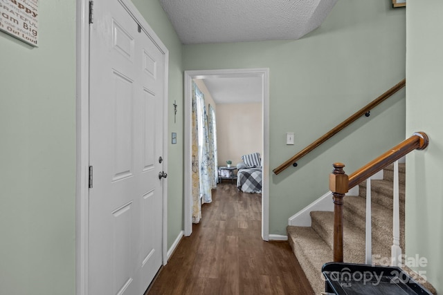 foyer with dark hardwood / wood-style floors and a textured ceiling