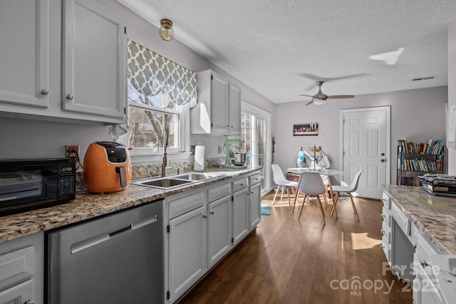 kitchen with a textured ceiling, dishwasher, white cabinetry, sink, and ceiling fan