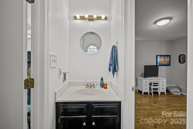 bathroom with vanity and hardwood / wood-style floors