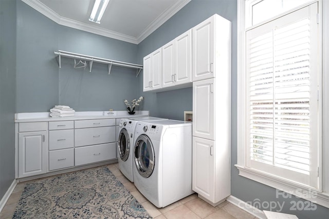 washroom with light tile patterned flooring, separate washer and dryer, ornamental molding, and cabinets