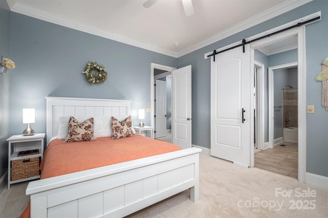 bedroom featuring light carpet, a barn door, ceiling fan, connected bathroom, and ornamental molding