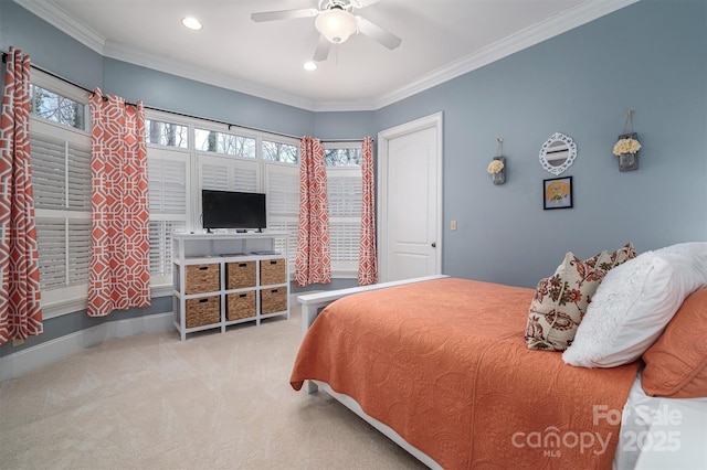 carpeted bedroom featuring ceiling fan and crown molding