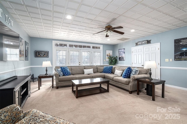 carpeted living room with ceiling fan