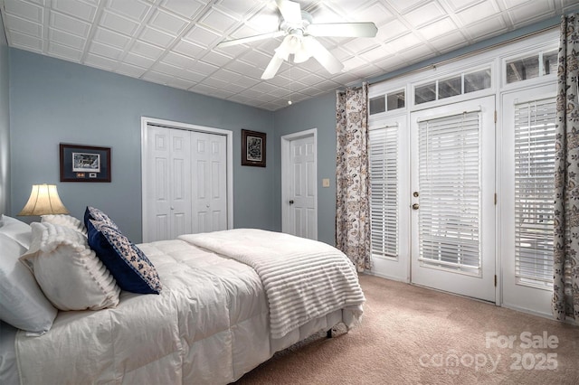 carpeted bedroom with ceiling fan, a closet, and access to outside