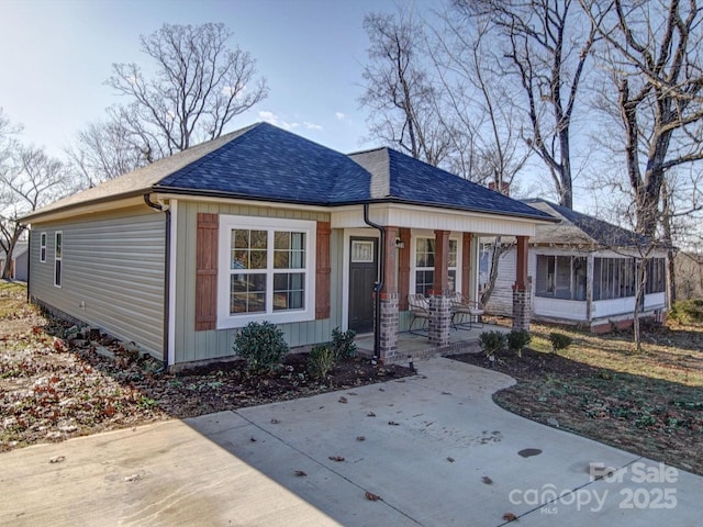 view of front of property with covered porch and a sunroom